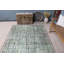 Tapis turc vintage vert avec un motif délavé unique pour une décoration intérieure élégante dans des tons pastel doux