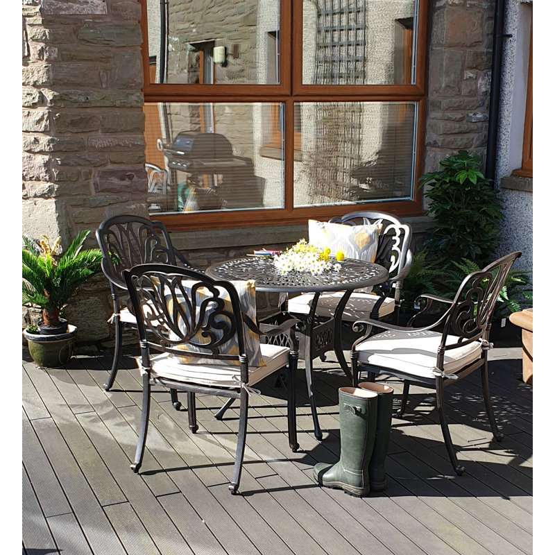 Paseo 4 - Person Patio Dining Set with Round Table , Cushions Included
