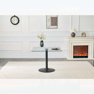 Table de salle à manger minimaliste avec base en métal à colonne unique, idéale pour les espaces compacts et une utilisation polyvalente.