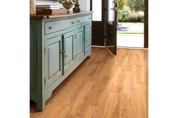 Wood-like vinyl plank flooring installed in an entryway with a large green accent cabinet.