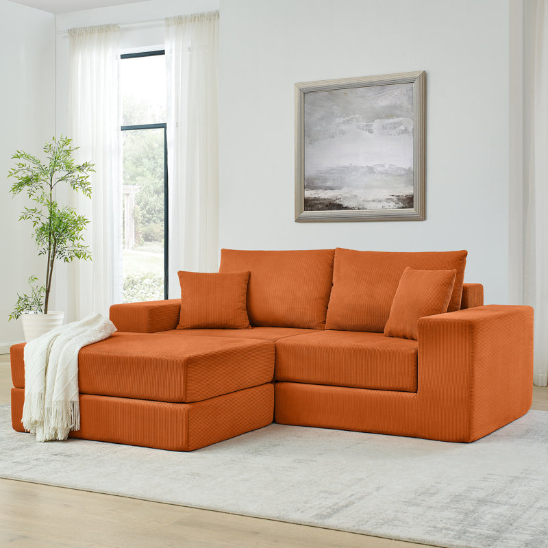 Canapé-lit modulaire orange moderne en forme de L avec assise amovible et profonde, revêtu de velours côtelé, idéal pour les petits espaces de salon, livré avec des coussins décoratifs, prêt à l'emploi.