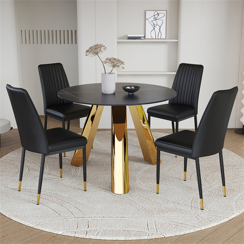 Une table de salle à manger ronde de 42 pouces avec un plateau en granit et des pieds en acier inoxydable