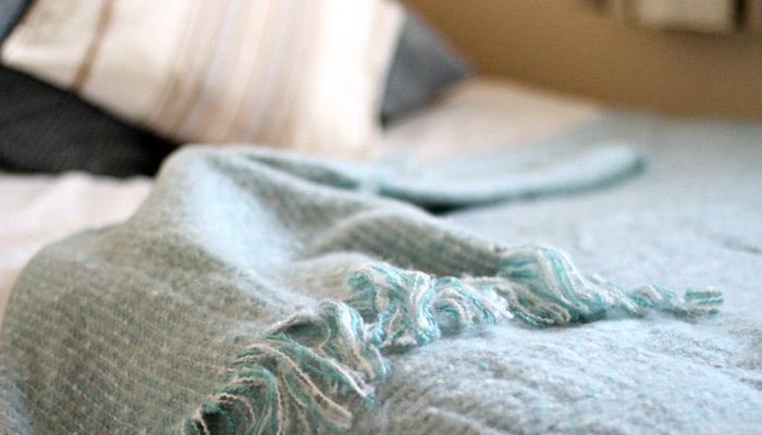 a soft throw blanket on a bed