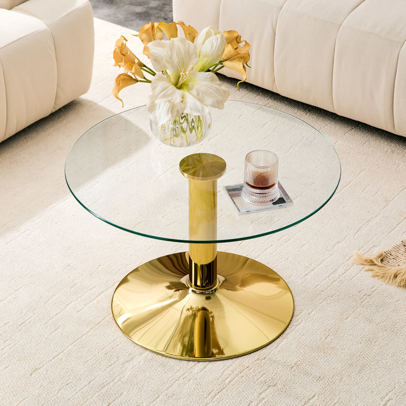 Table basse ronde en verre trempé de 27,5 pouces de diamètre. 17,7 pouces de haut, soutenu par une base en métal doré, avec un bord de luxe léger.