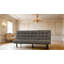 Canapé futon gris foncé avec capitonnage biscuit et appui-tête réglable, convertible en méridienne ou en lit pour un confort polyvalent
