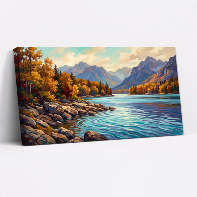 Tableau sur toile représentant un lac bleu et un rivage rocheux avec des arbres dorés d'automne