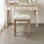 Tabouret de coiffeuse Fornear en lin, pieds en bois massif sculpté, banc de toilette au design capitonné-355506212