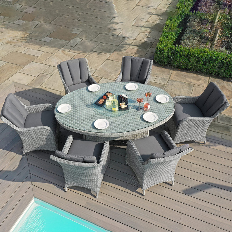 Crimora 6 - Person Wicker Patio Dining Set with Round Table , Cushions Included