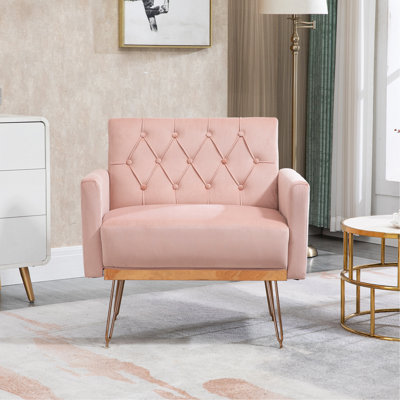 Fauteuil simple en velours avec revêtement capitonné et pieds en métal doré pour une assise élégante et confortable