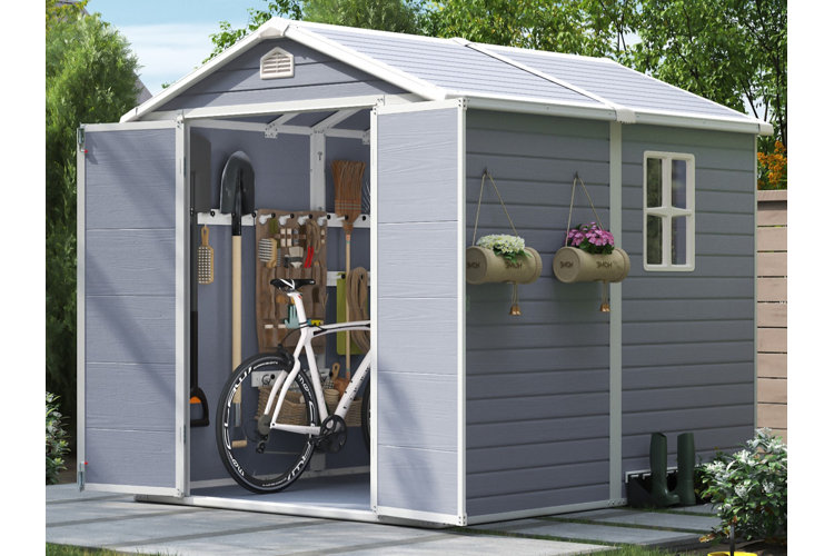gray storage shed with tool storage inside. hanging shovel and broom and pegboard