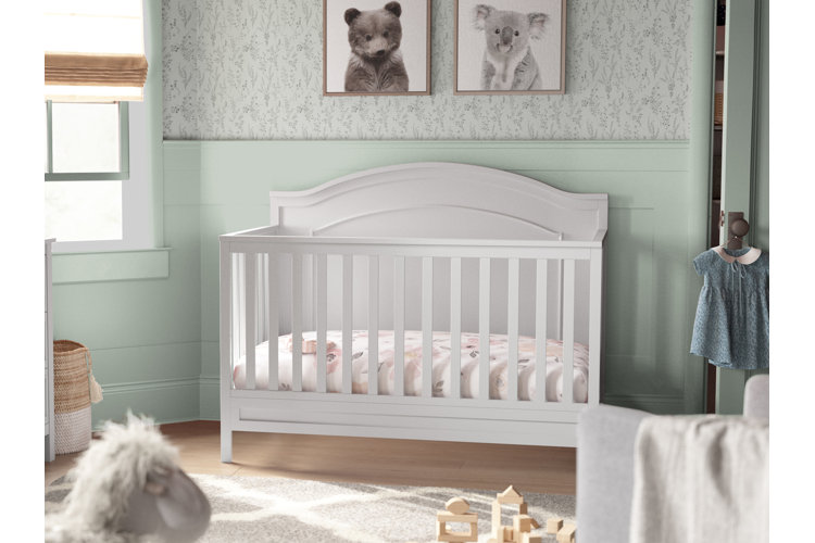 Baby nursery with a standard crib and crib mattress.