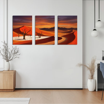 Ensemble de 3 tableaux sur toile représentant un paysage désertique avec dunes et arbres dénudés.