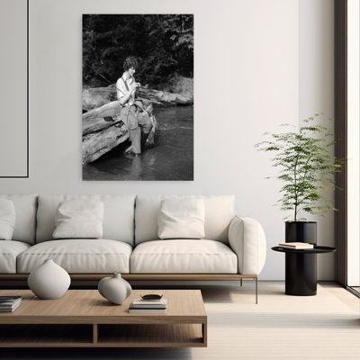 1920s 1930s WOMAN SITTING ON ROCK BY SIDE OF STREAM WEARING WADERS PUTTING FLY ON TIPPET by H. Armstrong Roberts - Wrapped Canvas Print
