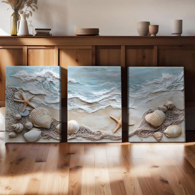 Ensemble de 3 affiches encadrées, toiles décoratives sur le thème de la mer, avec vagues texturées, coquillages, étoiles de mer et filets en relief. Décoration nautique idéale pour le salon, la chambre ou la salle de bain. Prêtes à accrocher.