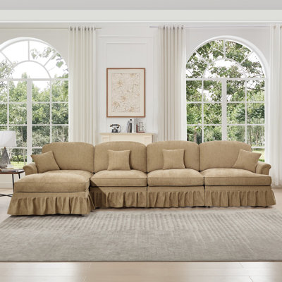 Canapé modulaire classique à trois places en forme de L avec accoudoirs évasés et volants amovibles, jupes plissées et pieds fuselés, canapé à quatre places en chenille confortable avec repose-pieds mobile