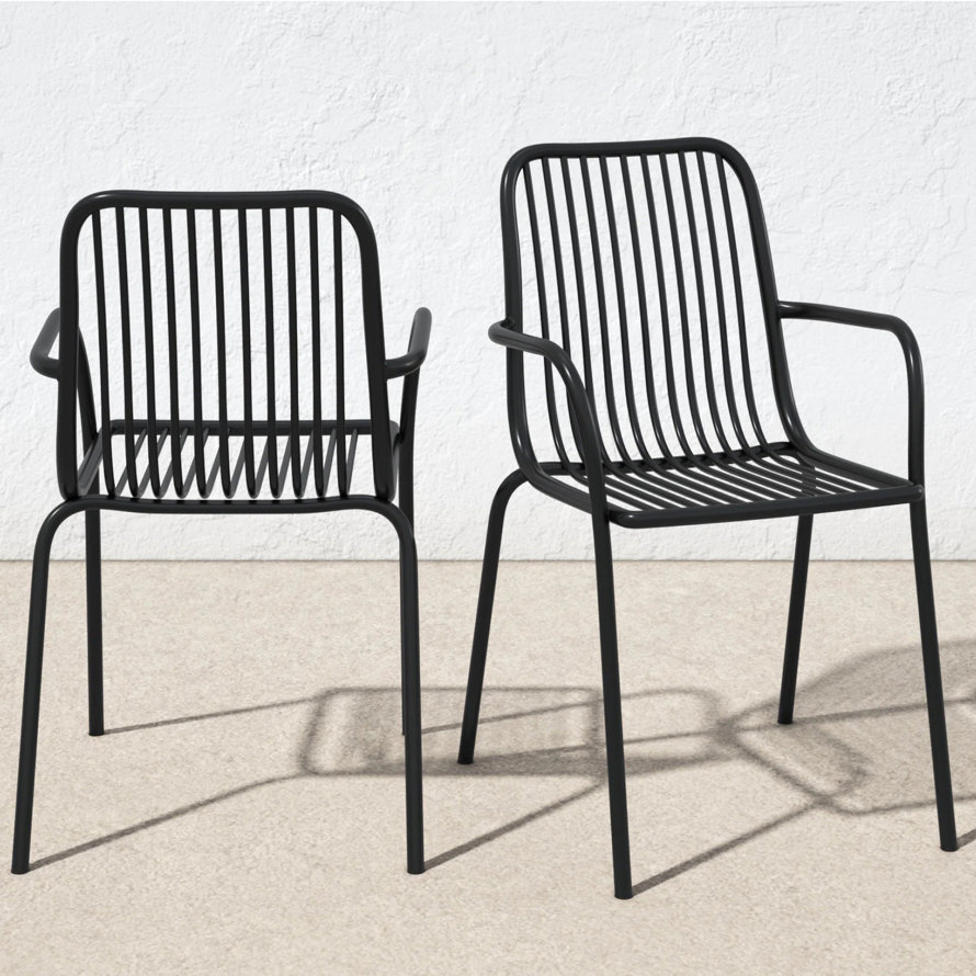Two black metal outdoor dining chairs with armrests.