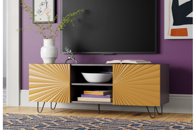 modern living room with a flat screen TV mounted on a purple wall