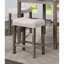 Table de salle à manger à hauteur de comptoir grise et beige avec tabourets très hauts rembourrés en tissu et 4 tabourets en lin