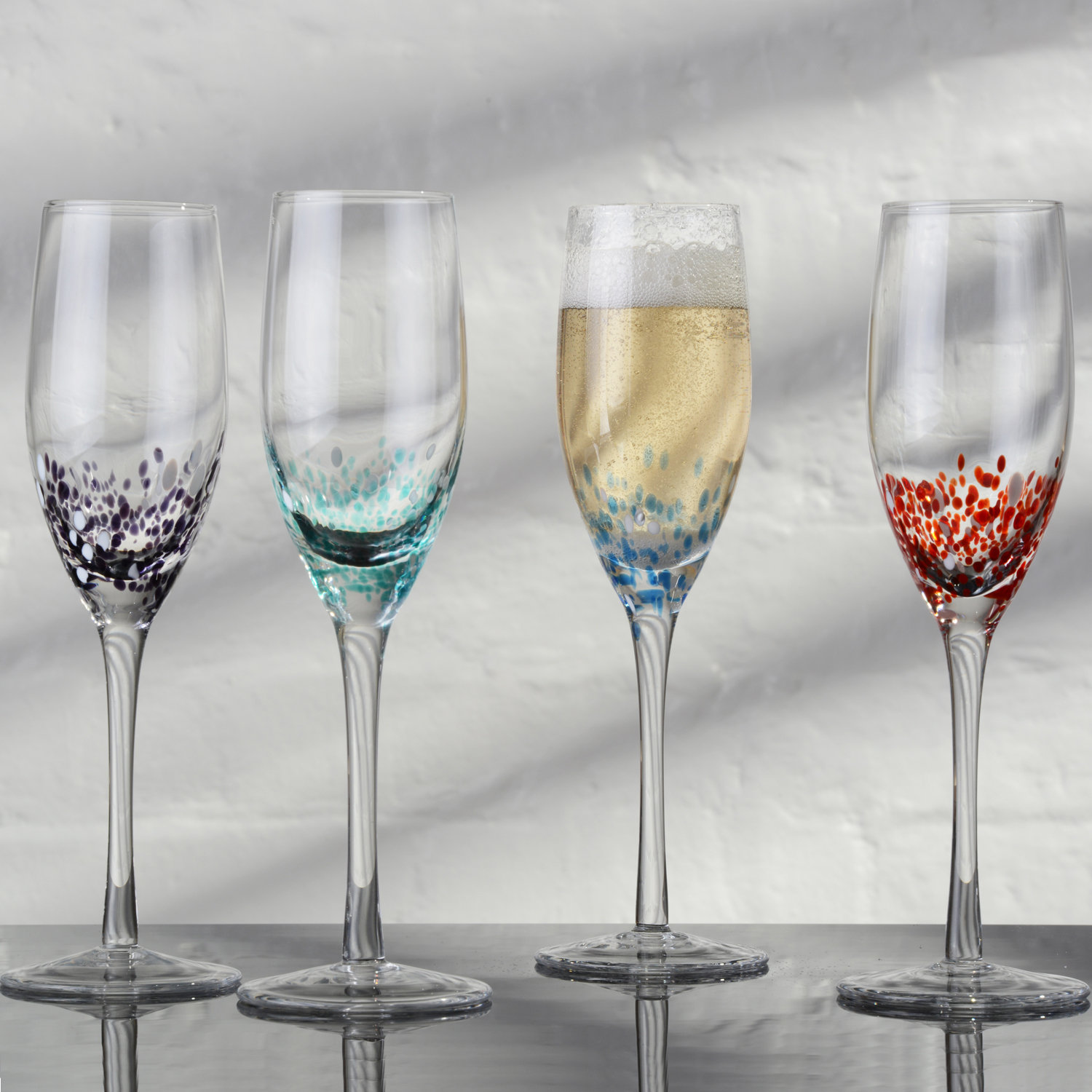 https://assets.wfcdn.com/im/20409309/compr-r85/2483/248388538/anton-studio-designs-4-piece-85oz-glass-flute-stemware-set.jpg