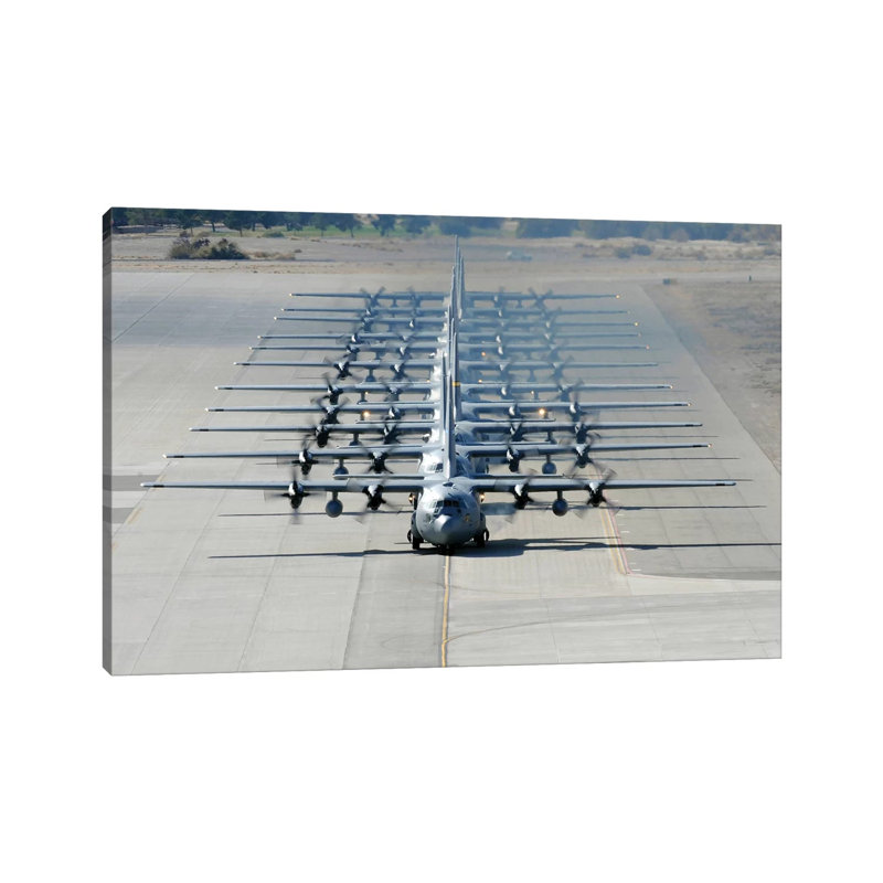 A Line Of C-130 Hercules Taxi At Nellis Air Force Base, Nevada by Stocktrek Images - Wrapped Canvas Print