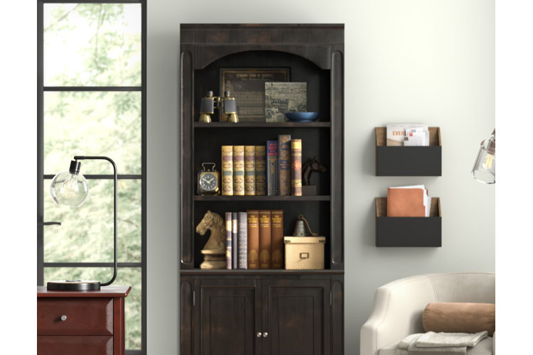 Shelf decor idea with old books, a horse chess piece bookend, and traditional decor spread across three bookcase shelves.