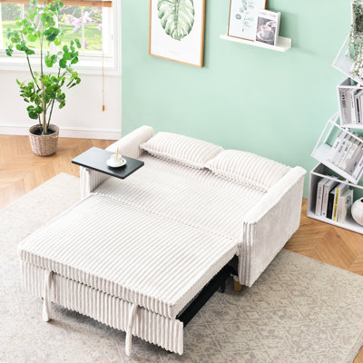 Lit en velours côtelé beige avec plateau mobile et fiche, créant une table de sommeil confortable, offrant une fonctionnalité de confort en une seule pièce