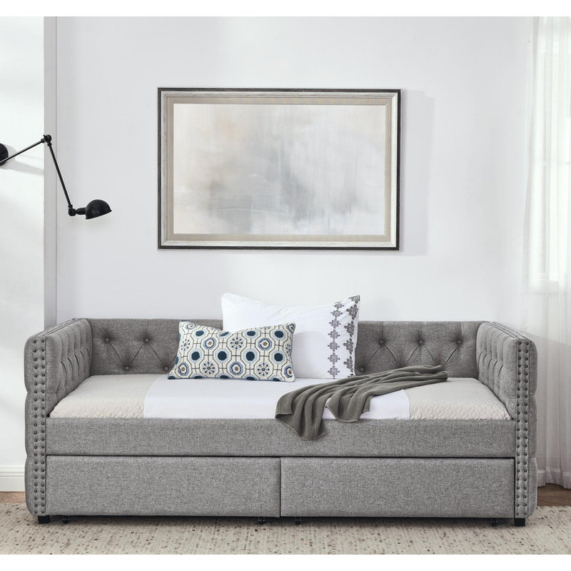 Twin sized upholstered daybed featuring two drawers, adorned with buttons and copper nails on its square arms, Grey