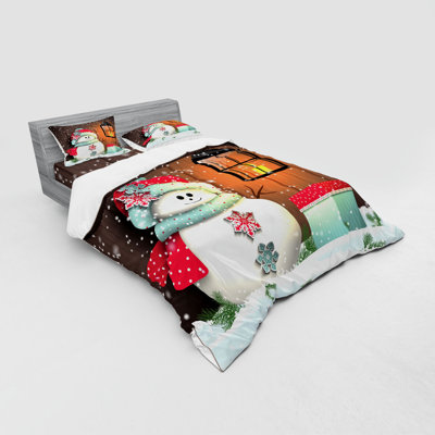 Ensemble de housse de couette bonhomme de neige avec père noël at the jardin avec une boîte-cadeau et une lanterne