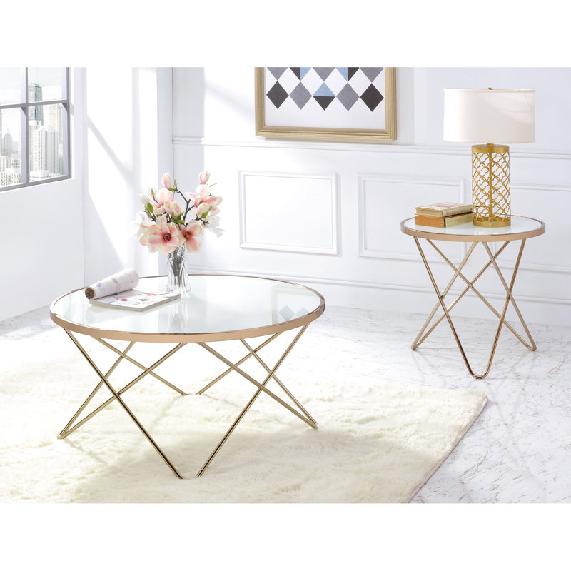 Table basse sophistiquée ronde avec verre givré et métal champagne de luxe