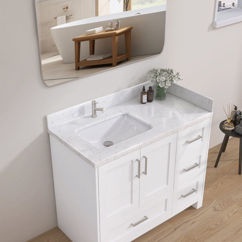 L 42 po x P 22 po en pierre reconstituée avec comptoir en céramique de Carrare et lavabo simple avec drain à gauche et comptoir rectangulaire en céramique Dosseret H