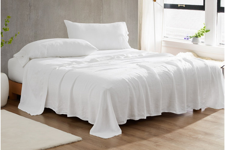 bed with crisp white linen sheets