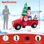 Grand père Noël conduisant une voiture gonflable
