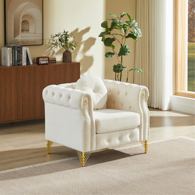 Canapé Chesterfield en velours avec coussins ronds, avec des clous en cuivre et des boutons capitonnés, avec des pieds en métal. La conception en boucle permet de suspendre des décorations.