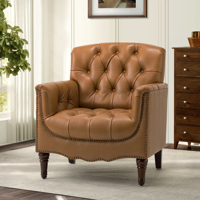 Fauteuil en cuir capitonné Annja