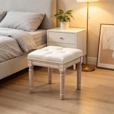Élégant tabouret d'appoint capitonné avec pieds en bois sculpté