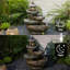 Fontaine en cascade à 4 niveaux en forme de pagode en résine avec des lumières DEL chaudes pour le jardin