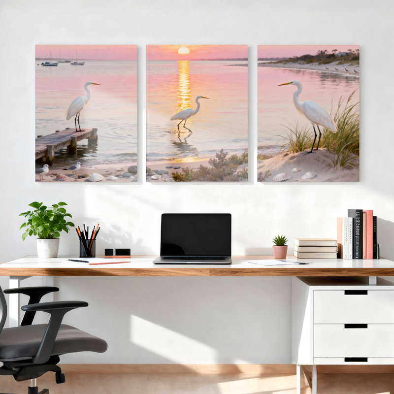 Ensemble de 3 toiles murales montées sur châssis représentant un coucher de soleil sur une plage avec un héron