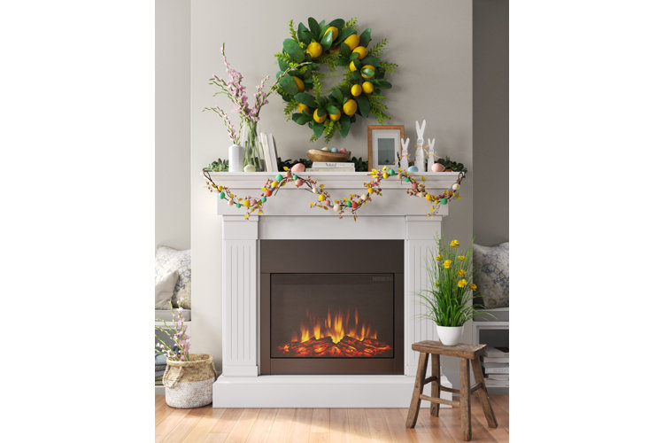 green floral wreath with lemon decorations hanging above a mantle