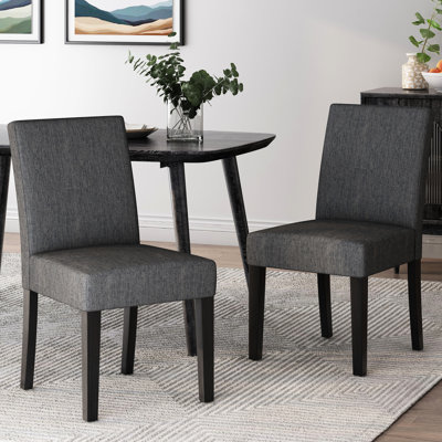 Chaise de salle à manger en tissu gris anthracite avec un revêtement harmonieux et lisse et des pieds fuselés élégants