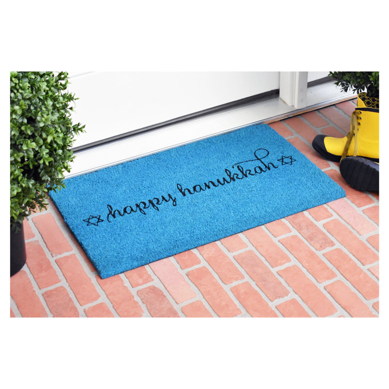 A blue Hanukkah doormat with black text