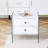 Double-drawer bedside table. The board surface is MDF with white grain sticker, and both sides are transparent tempered glass. The design is simple and elegant, with excellent storage functions.