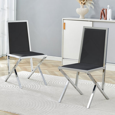 Ensemble de 2 chaises de salle à manger ergonomiques en polyuréthane noir avec structure en métal argenté, design moderne et stabilité accrue pour un usage quotidien.