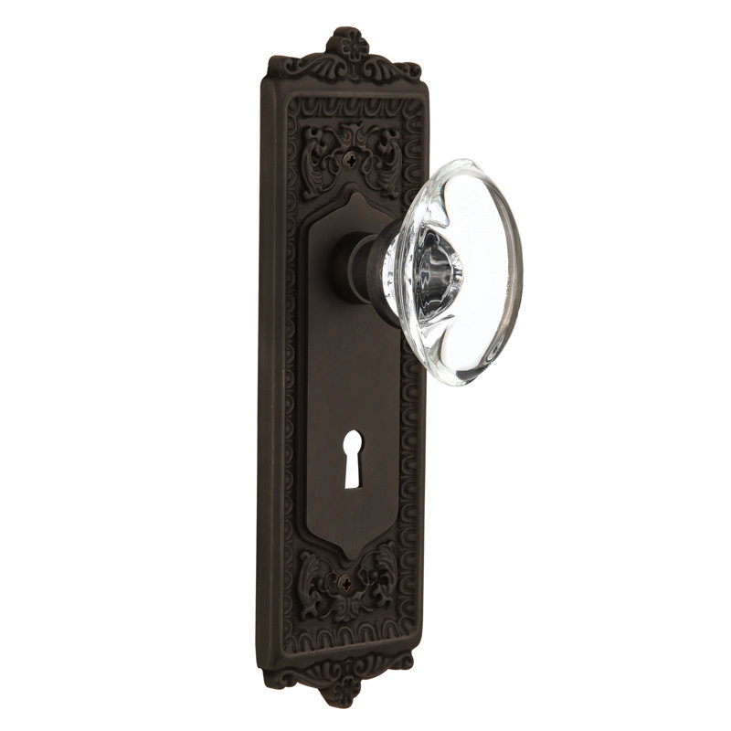 Egg & Dart Plate avec trou de serrure décoratif et bouton de porte ovale en cristal transparent, Bronze frotté à l'huile