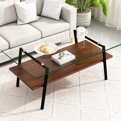 Élégante table basse de salon avec plateau en verre transparent et pieds en métal