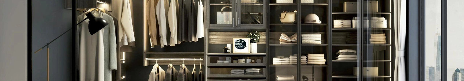 Modern walk-in closet featuring organized hanging rods, glass-front shelving with folded clothes and accessories, and a framed sign that reads Better than nothing.