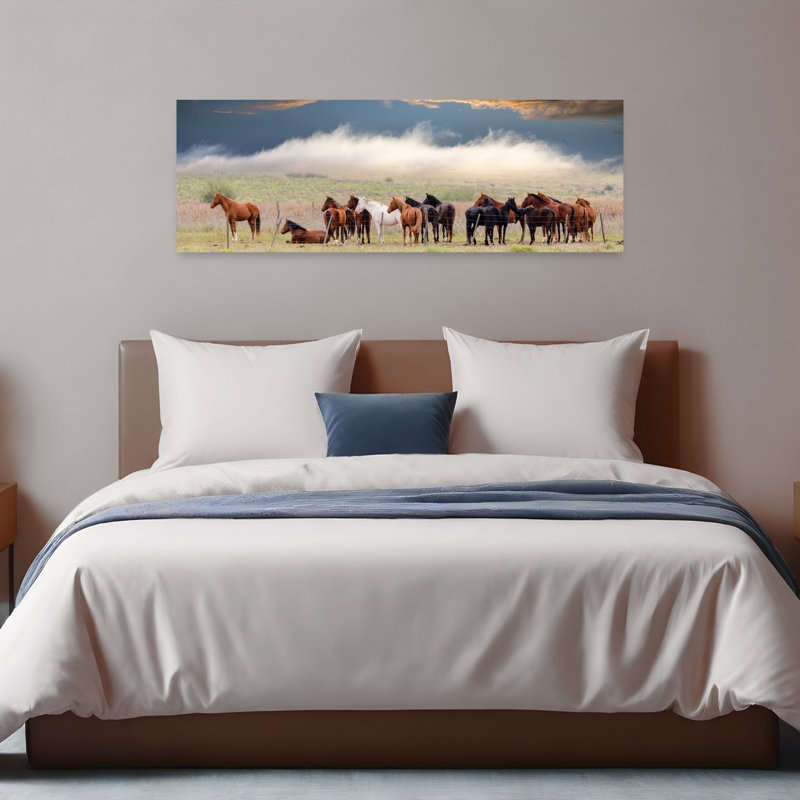 Horses Under Dramatic Sky by Chechi Peinado - Wrapped Canvas Panoramic Print, 40.64 cm H x 121.92 cm W