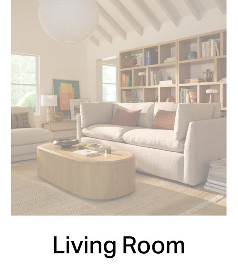 Modern living room featuring a plush cream sofa, light wood coffee table, and built-in shelving, labeled Living Room.