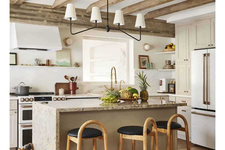White kitchen with modern white appliances, rustic wood beams, and coastal decor.