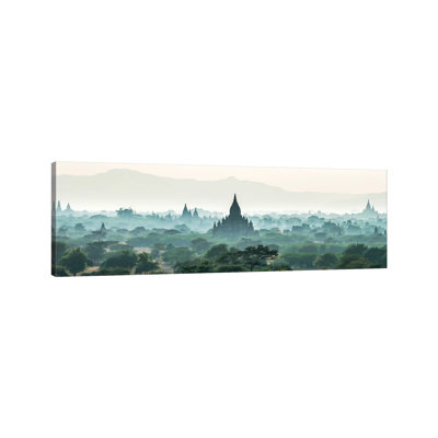 Early Morning Fog Over The Temples In Bagan, Myanmar by Jan Becke - Wrapped Canvas Panoramic Print