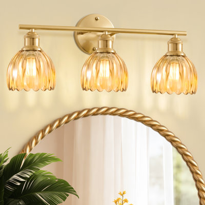 Applique murale à 3 lumières en or brossé avec abat-jour en verre ambré de type tulipe, idéale pour la salle de bain, la chambre ou le salon.